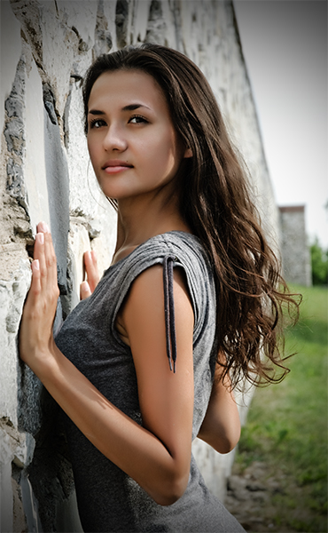 The girl at a wall leaving in a distance